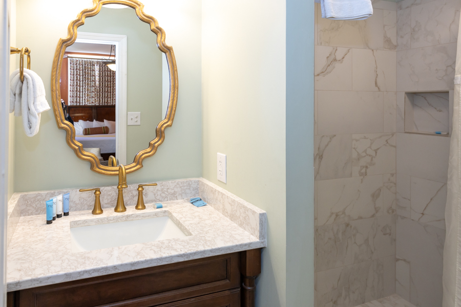 a bathroom with a mirror and a shower
