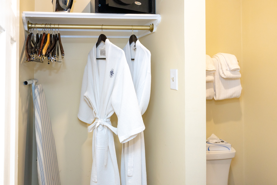 a white robe on a rack
