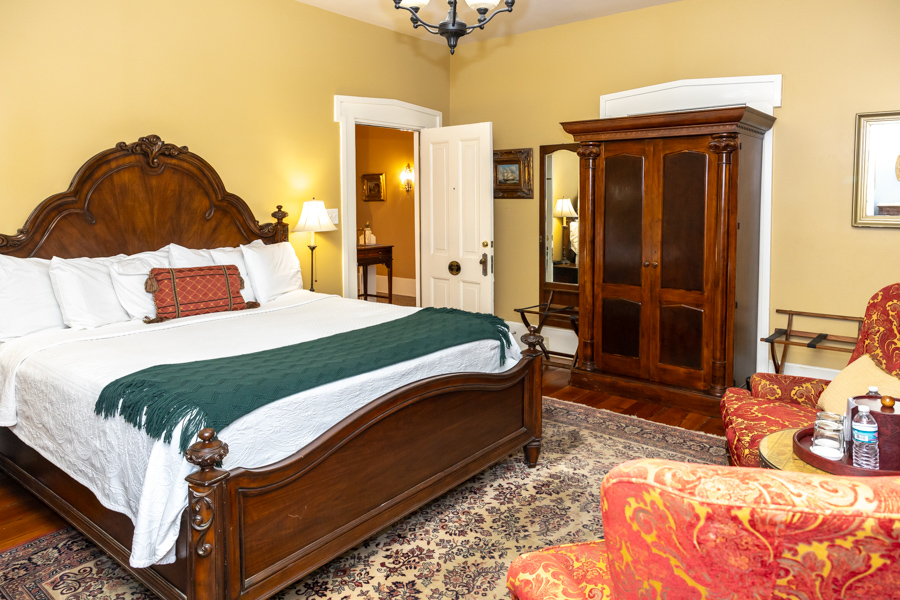 a bedroom with a large bed and a large cabinet
