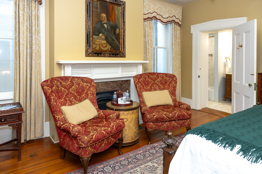 a room with a fireplace and two chairs
