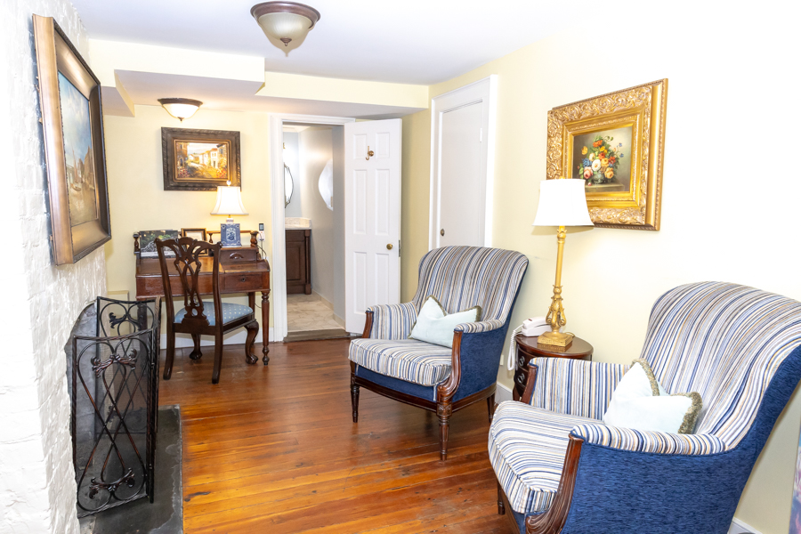 a living room with a fireplace and chairs
