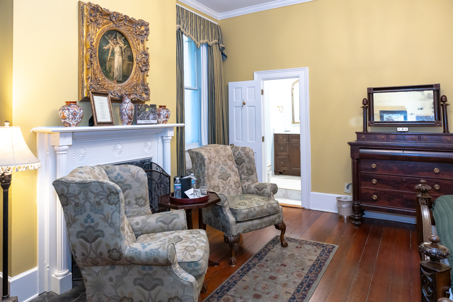 a room with a fireplace and chairs
