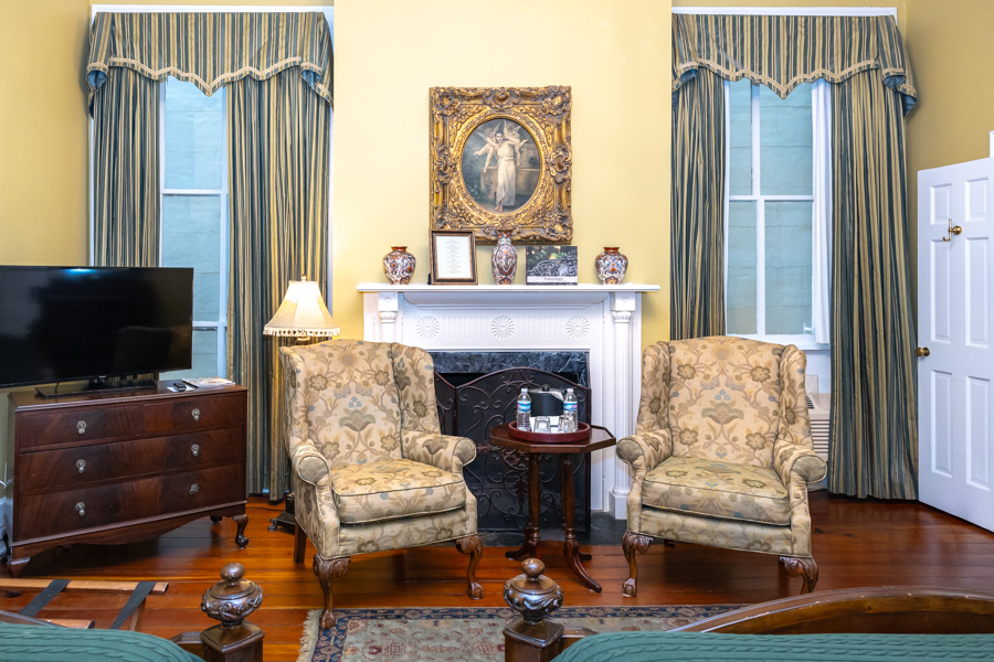 a room with a fireplace and chairs
