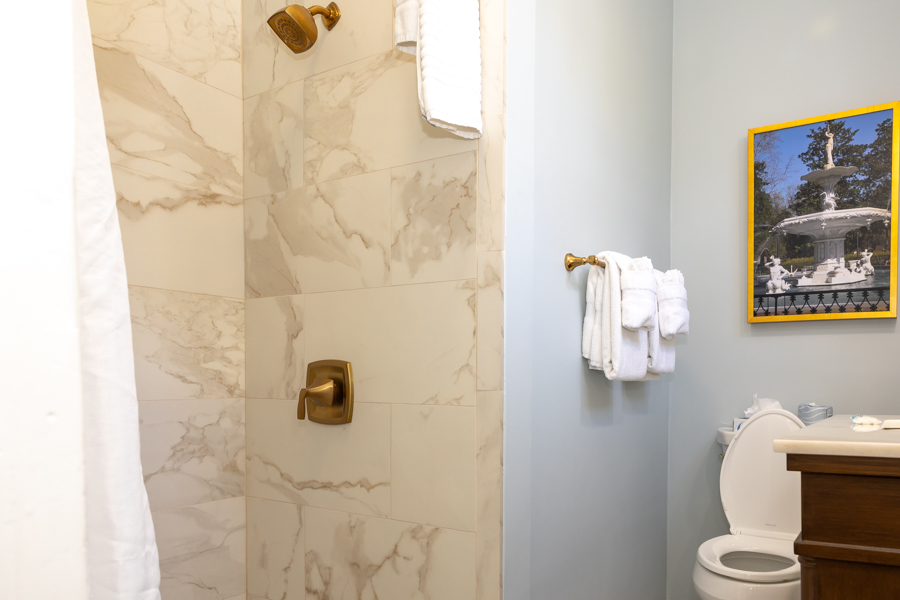 a bathroom with marble walls and a shower
